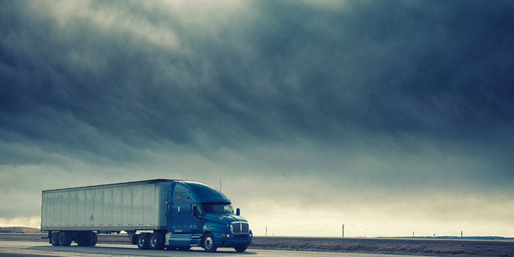 Freight truck driving on the road – Sinford’s reliable road freight and cross-border transport services