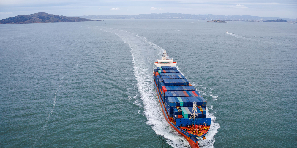 Cargo ship at sea loaded with containers – Sinford’s international sea freight services