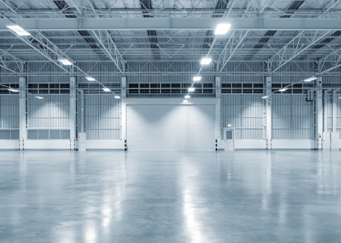 Warehouse receiving and dispatch loading doors with trucks positioned for loading and unloading goods, representing logistics consulting services.